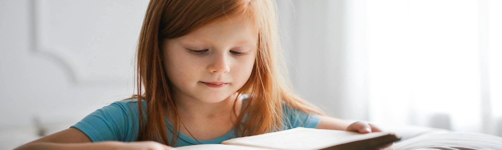 School child reading book